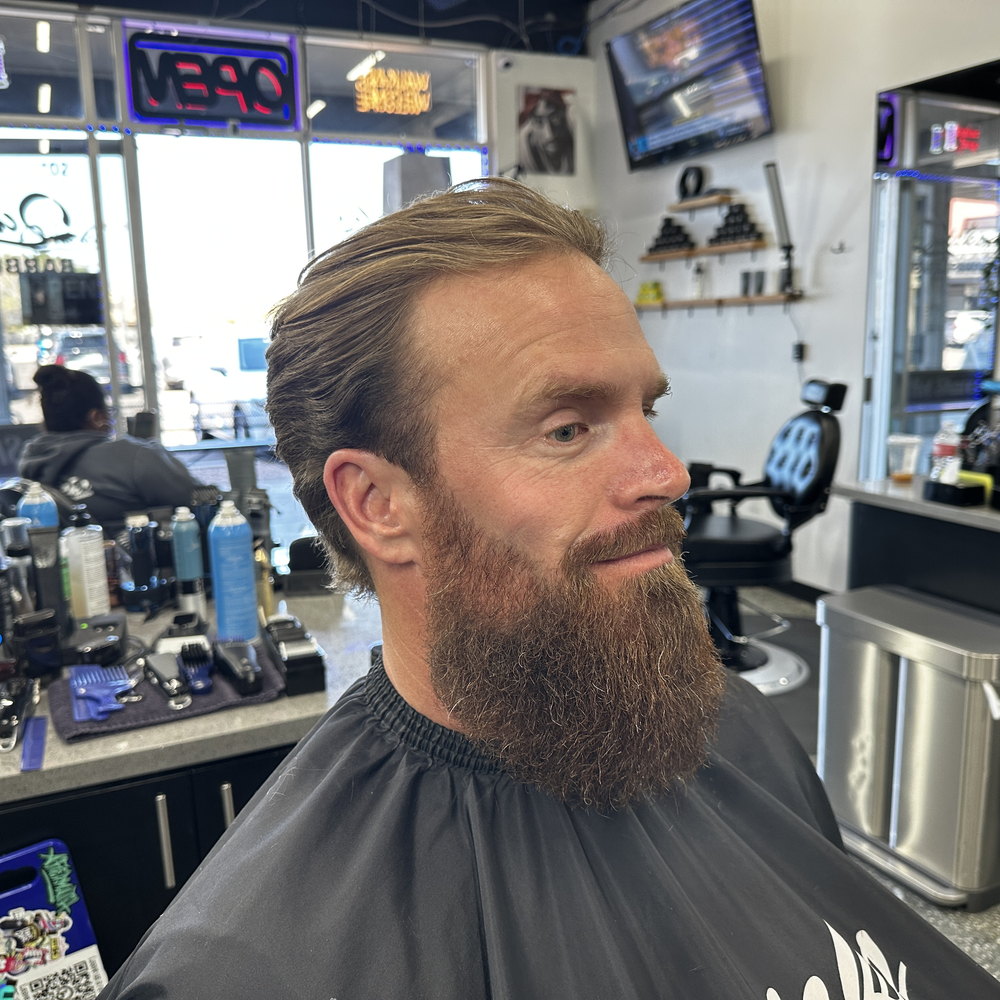A full beard trimmed and lined, facing the camera