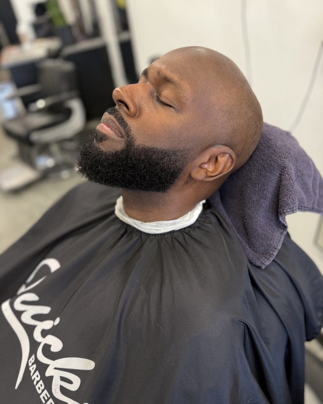 A hot towel and a straight-razor finish on a full beard