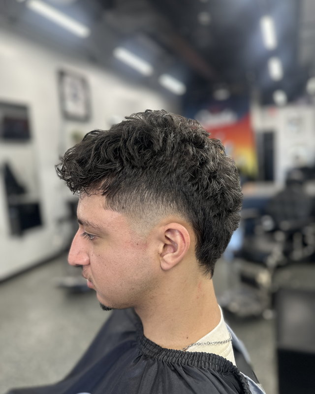 A curly crop with a faded back and sides