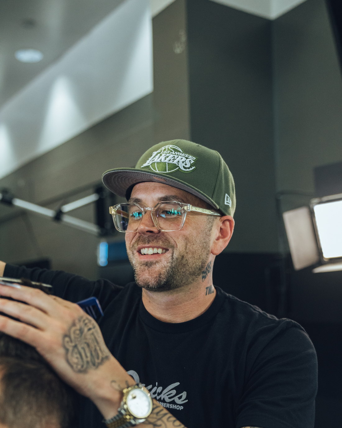 Mike cutting a client's hair at Quicks Barbershop