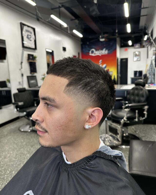 A crop fade on straight dark hair, skin taper at the ear