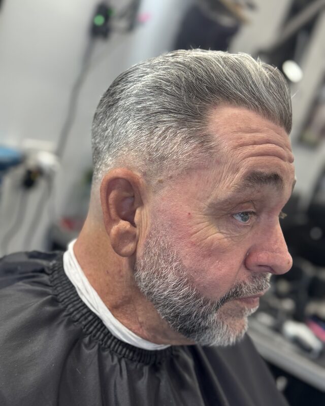 A scissor cut and beard trim on grey hair