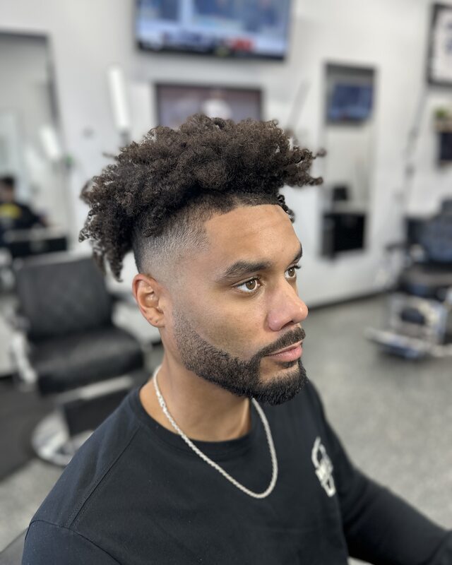 An afro taper with a full beard lined up