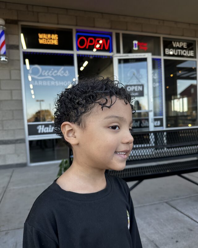 A child's curly cut, photographed outside the shop