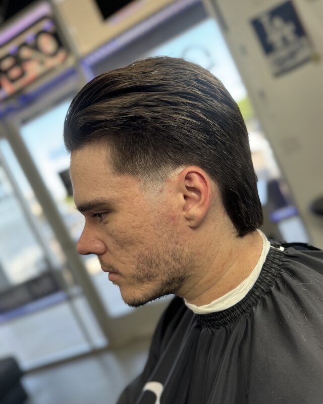 A longer slicked-back cut with a tapered neck