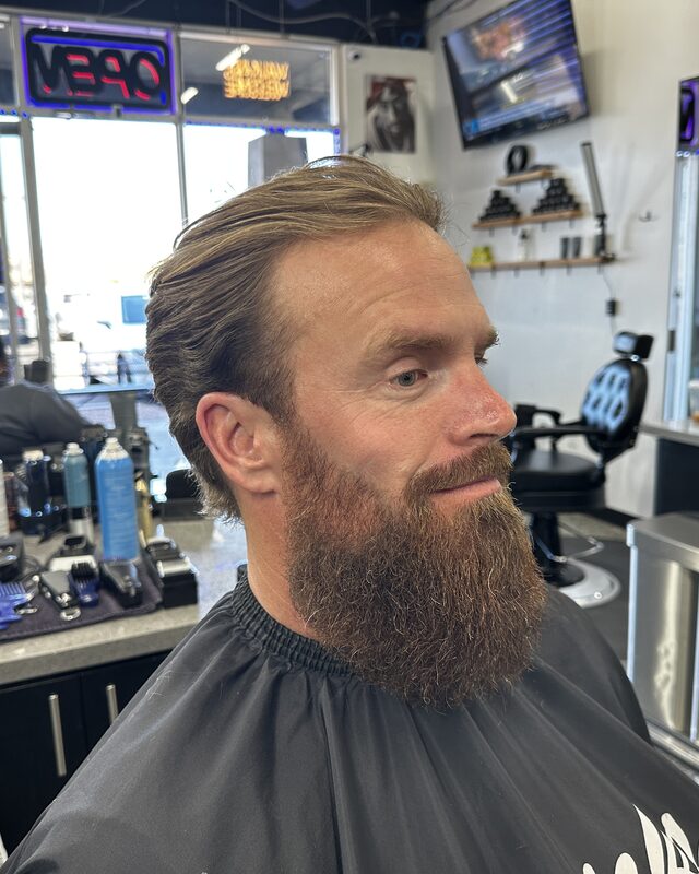 A full red beard shaped and a tapered cut
