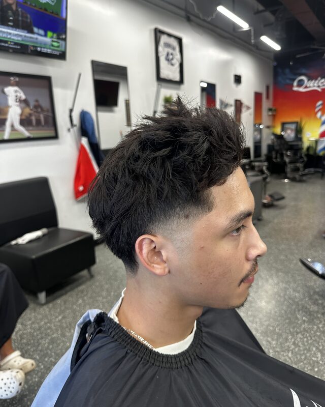 A textured quiff over a mid fade